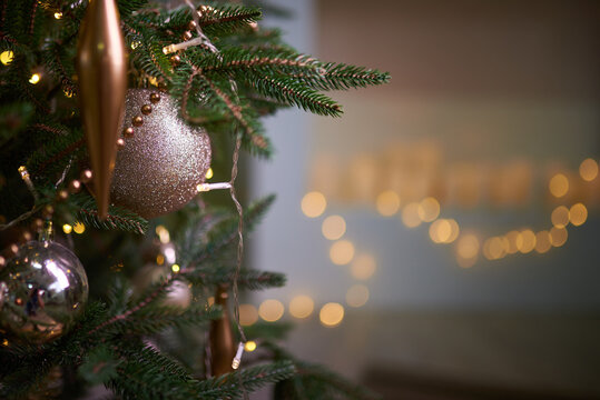 Decorated christmas tree, ornaments against a Defocused Lights Background