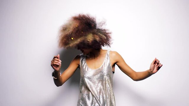 Dance, music and fun with a black woman in studio on a gray background waving her afro between mockup. Party, glitter and freedom with a female dancing with a carefree attitude in a sparkle dress