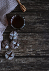 round homemade gingerbread with honey and powdered sugar on a dark wooden background