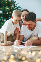 Family writing a letter to Santa Claus