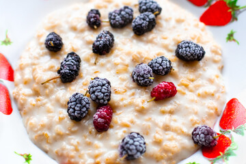 oatmeal with frozen mulberries. Delicious healthy breakfast. Close-up, selective focus.