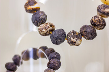 Dark amber beads on the glass shelf