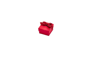 Red gift box with red ribbon bow with gold border on lid for ring or jewelry on white background, Valentine's Day