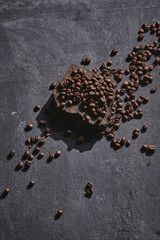 Roasted coffee beans on stone pedestal gray background