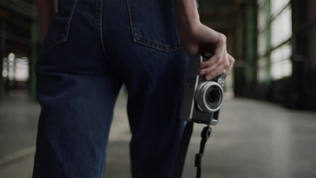 Back view of woman walking with her camera, artsy conceptual video footage.