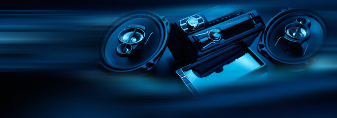 Black car sound speakers and radio tape recorder close-up on black background, audio system, hard...