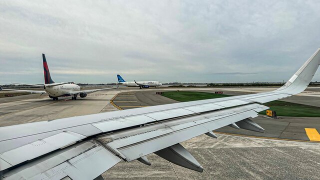 Planes Line Up At JFK Airport, One Of The Top 10 Busiest Airports In The US.