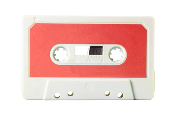 Isolated closeup front shot: an old vintage cassette tape (obsolete music technology). Cream red peach label over a white plastic body.
