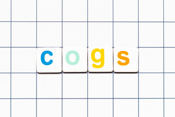 Colorful tile letter in word COGS (Abbreviation of Cost of goods sold) on white grid background