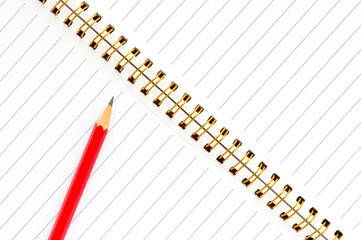 Notebook, pencil, eraser and pencil sharpener on a desk