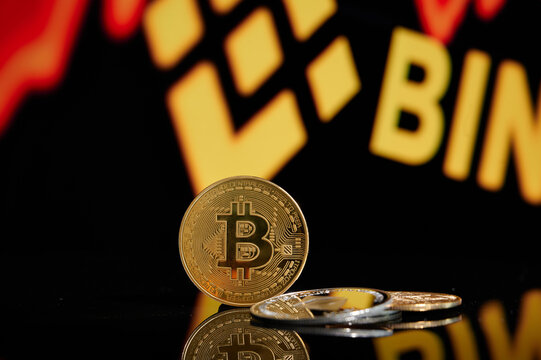 Bitcoin BTC and Ethereum ETH on stack of cryptocurrencies with Binance coin logo in background. The cryptocurrency coin is golden and in focus. Minsk Belarus - 01 05 2022