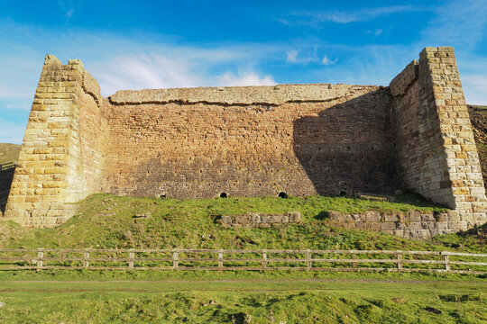 The ruins of one of the massive ironstone kilns used for roasting the ore mined from the hillside, East Rosedale Mines on the Rosedale Ironstone Railway, North York Moors National Park, UK - Powered by Adobe