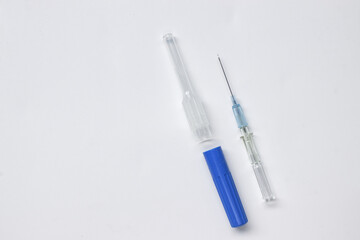 IV catheter with a needle sheath placed on white background.