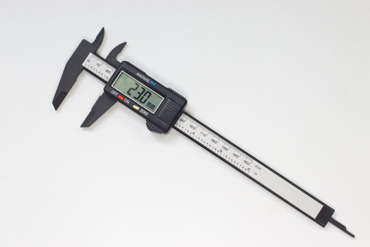 Electronic digital caliper on white background, the precision to