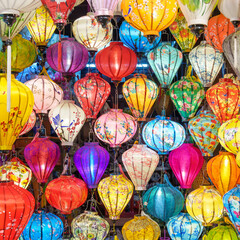 Fototapeta na wymiar Colorful lanterns at night market in Hoi An ancient town in central Vietnam, landmark and popular for tourist attractions. Vietnam and Southeast Asia travel concept