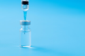 Syringe insertion ampoule on blue background