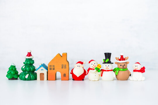Christmas decoration items on white background, cute little Christmas doll with house model