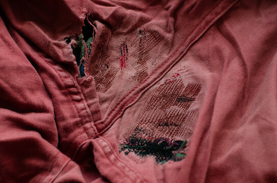 repair garments, mending destroyed  red trousers detail