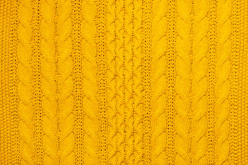 Bright yellow macro photo of textured jersey and knitting of sweater or sweatshirt. Pattern and background for fashion Warm Autumn concept