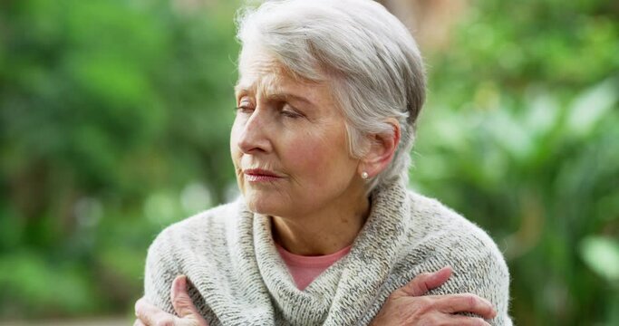Elderly woman, dementia or anxiety in park with stress, worry and paranoid while sitting outdoor. Senior, retirement and scared with psychology problem, alzheimers or mental health on bench in nature