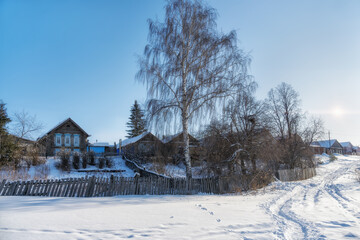 Old street with wooden houses on a sunny winter day. Nevyansk (Ural, Russia)