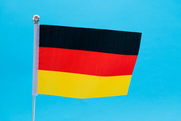 German flag waving on blue background