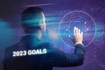 Business, technology, internet and network concept. Young businessman thinks over the steps for successful growth: 2023 goals