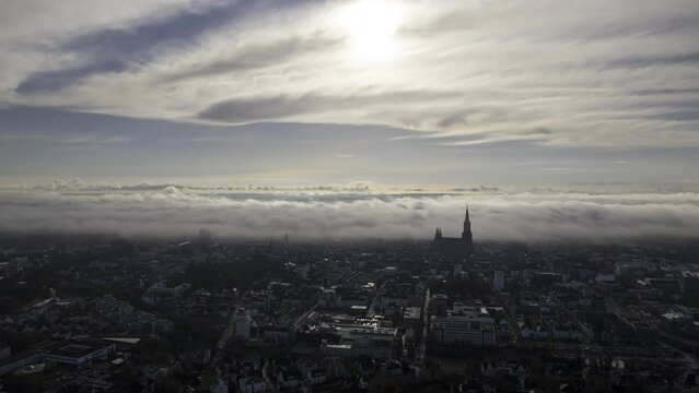 Ulm city center with minster on a morning with low clouds aerial time lapse