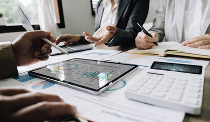 Fototapeta premium Business People Meeting using laptop computer,calculator,notebook,stock market chart paper for analysis Plans to improve quality next month. Conference Discussion Corporate Concept
