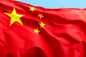 Chinese flag waving on blue background