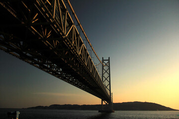 Akashi Kaikyo Bridge or Kobe Bridge with beautiful sunset, mountain and ocean view at Japan.