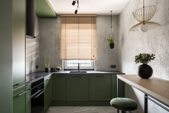 Spacious and modern kitchen with green furniture