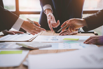 Business people using pen,tablet,notebook are planning a marketing plan to improve the quality of their sales in the future. Business Corporate People Working Concept