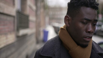 Fototapeta na wymiar Upset black man walking in city. Angry frustrated person emotion