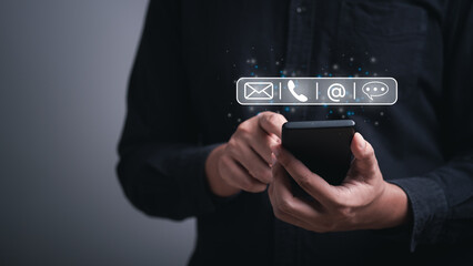 hand using smartphone typing, chatting on application Communication and conversation,mail working, in chat box icons pop up. Social media maketing technology concept.