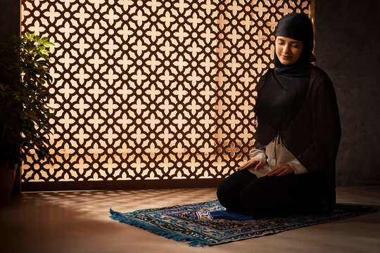 Portrait of a Muslim woman praying at home