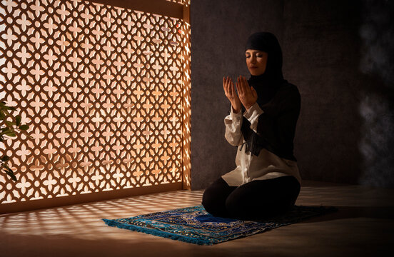 Portrait of a Muslim woman praying at home