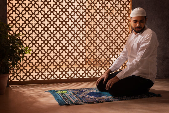 Portrait of a Muslim man praying at home