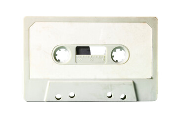 Isolated old vintage cassette tape from the 1980s (obsolete music technology). White label, light gray plastic body.
