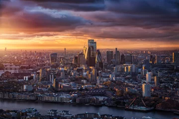Poster The skyline of the City of London with the modern office skyscrapers reflecting the warm sunlight of a cloudy winter sunset, England © moofushi