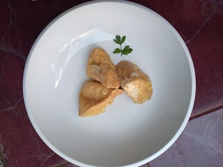 Fried tofu on the white plate. Tofu is made from fermented soybean extract. And tofu has a savory taste after cooking. can for lunch