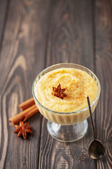 Curau de Milho (Brazilian Corn Pudding). Traditional Brazilian dessert. Corn porridge with cinnamon in a bowl.