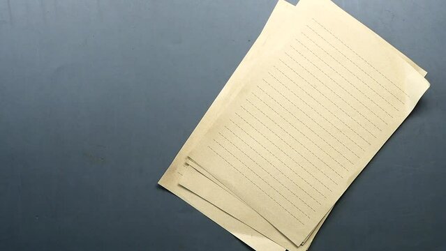 slow motion of dropping paper and pen on table 