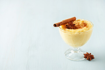 Curau de Milho (Brazilian Corn Pudding). Traditional Brazilian dessert. Corn porridge with cinnamon in a bowl.
