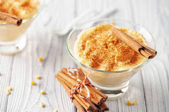 Curau de Milho (Brazilian Corn Pudding). Traditional Brazilian dessert. Corn porridge with cinnamon in a bowl.