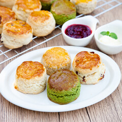 Four flavours of homemade scone with raspberry jam and clotted cream (butter, cranberry, matcha and Earl Grey)