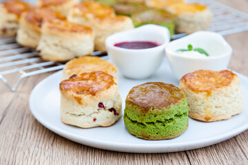 Four flavours of homemade scone with raspberry jam and clotted cream (butter, cranberry, matcha and Earl Grey)