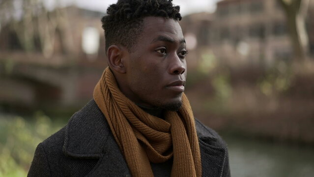 Young black man walking outside in nature during winter season2