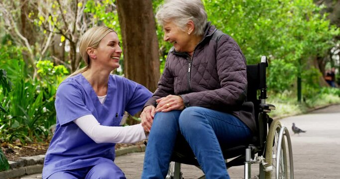 Wheelchair, Park And Nurse Talking To Senior Woman For Disability Healthcare, Support And Mental Health Wellness In Green Nature. Disabled Elderly Or Old Woman Retirement With Her Caregiver In Garden