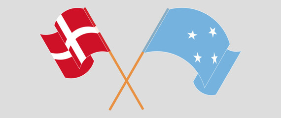 Crossed and waving flags of Denmark and Micronesia